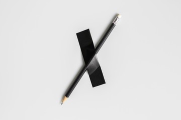 black pencil pinned with black cloth tape.