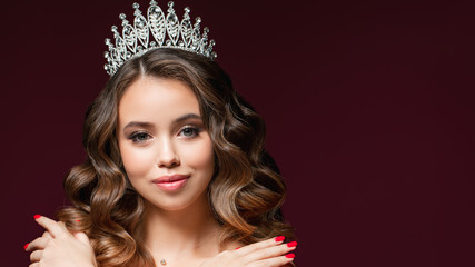 Beautiful portrait of young woman with perfect make-up, hairstyle, and nail design. Beauty contest. Crown on her head © Ксения Левашова