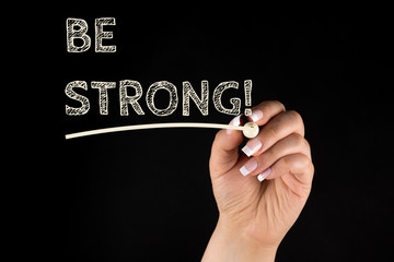 Be Strong, Handwritten by a woman With Marker pen on black background