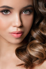 Fototapeta premium Beautiful portrait of young woman with perfect make-up, hairstyle, clear view. Party make-up with false eyelashes. Studio shot