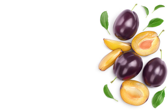 fresh purple plum and half with leaves isolated on white background with clipping path and copy spase for your text. Top view. Flat lay