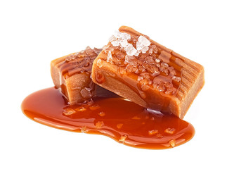 Melted caramel candies with sea salt isolated on a white background