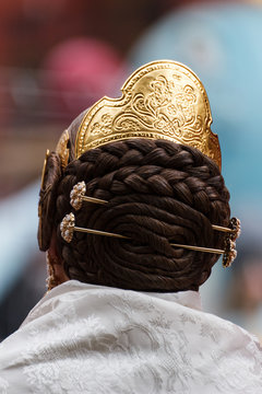 Hairstyle, jewelry and ornaments of a woman fallera in Fallas parties in Valencia, Spain.