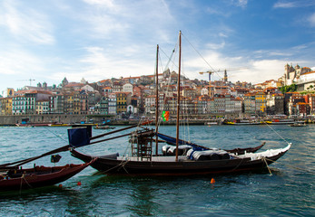 Portugal, Porto, colored houses of old town in Porto, colorful boats on Douro river, Porto by river, Porto old town view, blue wooden boats on the river, portuguese flag on karma of boat