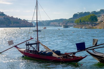 Portugal,  Porto, red wooden boat with wine port barrels close up on Douro, Porto by river,  Porto in summer, riverbed Douro, Porto city alone the river Douro