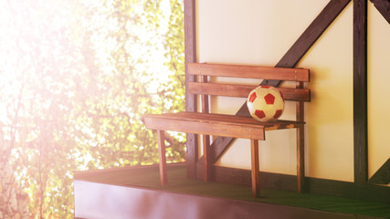 Soccer ball on a bench near the house
