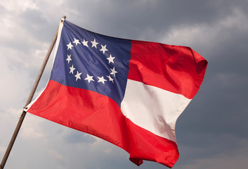 Naklejka na ściany i meble US Civil War 13 Star Confederate National Flag Against a Stormy Sky