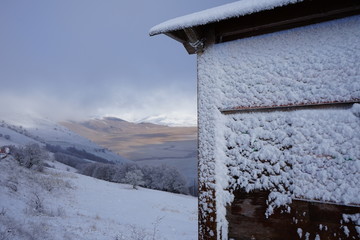 Sign covered by freeze and snow in a winter mountain day in Castelluccio, Norcia, Umbria, Italia