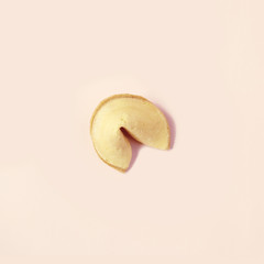 fortune cookie on pastel pink background