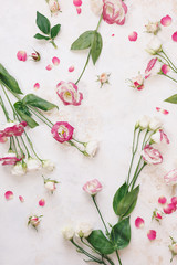 Beautiful fresh lisianthus  or Japanese roses flowers scattered  on rustic white and gold surface. Top view, blank space