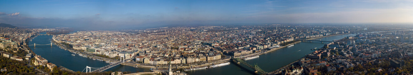 Fototapeta na wymiar Panorama of the city of Budapest shot on the hills of Gellert with the help of a drone. Top view of all sights near the Danube river.