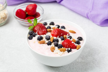 Healthy Breakfast berry cocktail bowl with strawberries, blueberries and almonds.