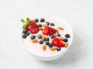 Healthy Breakfast berry cocktail bowl with strawberries, blueberries and almonds.