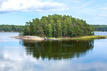 Fototapeta na wymiar View of the island and it's reflection in the sea water, Linlo, Kirkkonummi, Finland