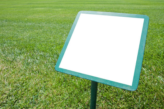 Blank advertising signboard in a green mowed lawn - concept image with copy space and space for inserting text