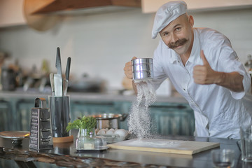 french chef in the kitchen preparing food, cooking, haute cuisine, man with mustache