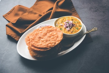 Dal pakwan is an authentic Sindhi breakfast. It is a combination of deepfried, crisp and unpuffed Maida puris served with Daal made using chana or split chickpea. selective focus