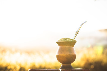 mate bowl, outdoors. Yerba mate typical of Argentina, Brazil and Uruguay. Mountain scenery in the...