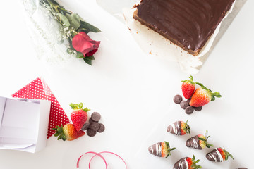 Valentines Day Background with Chocolate Strawberries, a Red Rose, and Brownies