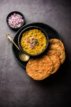 Dal pakwan is an authentic Sindhi breakfast. It is a combination of deepfried, crisp and unpuffed Maida puris served with Daal made using chana or split chickpea. selective focus