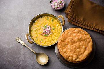 Dal pakwan is an authentic Sindhi breakfast. It is a combination of deepfried, crisp and unpuffed Maida puris served with Daal made using chana or split chickpea. selective focus