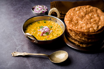 Dal pakwan is an authentic Sindhi breakfast. It is a combination of deepfried, crisp and unpuffed Maida puris served with Daal made using chana or split chickpea. selective focus