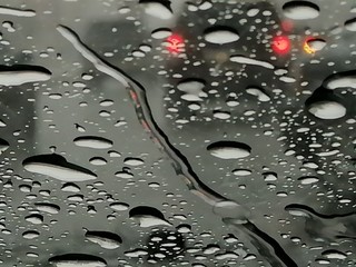 Raindrops on the glass, from the car in traffic