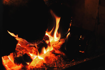 Fototapeta premium Burning firewood ember in fireplace