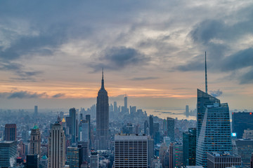 New York skyline from The Top of The Rock at sunset with clouds in the sky in the background