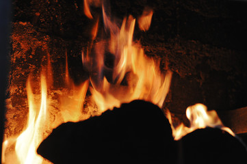 Burning firewood ember in fireplace