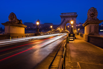 Beautiful Long exposure image of Chain Bridge in Budapest, Hungary. View of light trails along the road. Night photography.