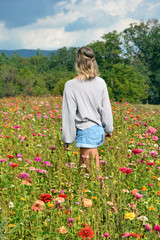 girl walking through field of mountain wildflowers