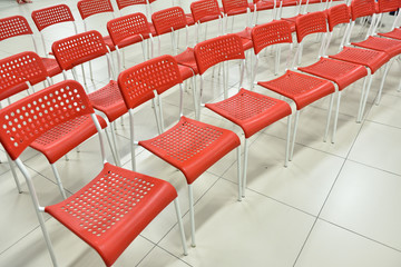 Empty red chairs in the auditorium for a conference or training in the office