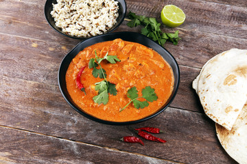 Chicken tikka masala spicy curry meat food in pot with rice and naan bread. indian food