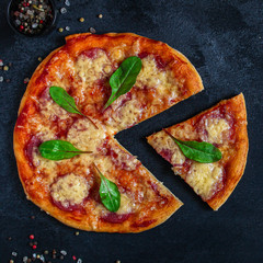 pizza salami sausages (tomato sauce, cheese, meat). food background. top view. copy space