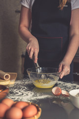 girl preparing cookies in the shape of a heart for the holiday Valentine's Day at home, in a small bakery, family business, authentic, hobby, mood, cozy. Care and love