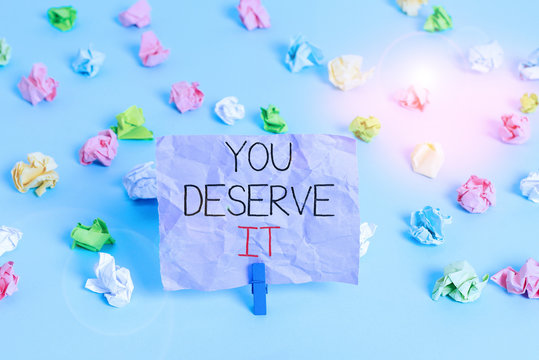 Writing note showing You Deserve It. Business concept for Reward for something well done Deserve Recognition award Colored crumpled papers empty reminder blue floor background clothespin