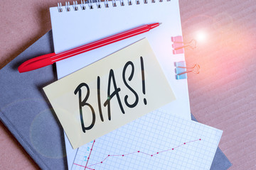 Word writing text Bias. Business photo showcasing inclination or prejudice for or against one demonstrating group Desk notebook paper office cardboard paperboard study supplies table chart