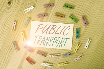 Text sign showing Public Transport. Business photo showcasing transport of passengers by group travel systems to public Colored clothespin papers empty reminder wooden floor background office