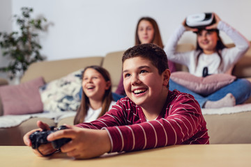 Teenagers playing video game at home.