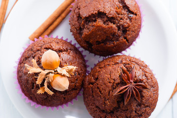 chocolate muffins with hazelnuts on white wooden