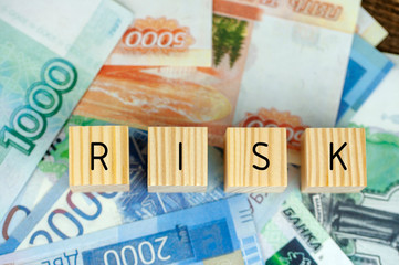 wooden blocks with the inscription risk and Russian money