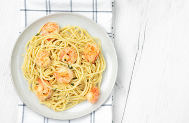 Pasta spaghetti with prawns on light background. Top view