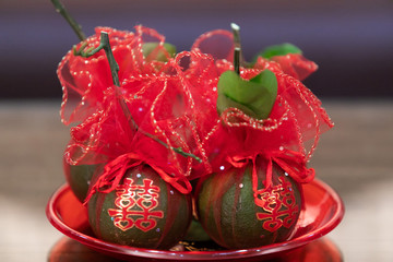 Tangerine Fruits in tray wrapped in red clothes, with Chinese Character stickers meaning Double Happiness, in Chinese Wedding Ceremony as appropriate for marriage gift. Symbol of Luck and Prosperity.