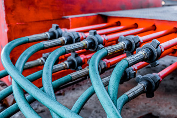 Hydraulic pressure pipes system of construction machinery. Close up shot of hydraulic pressure hoses. Block hydraulic hoses. High pressure hoses are connected by hydraulic connectors.