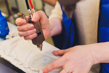 Hand Laundry worker in the process of removing stains by using a special dry-cleaning.