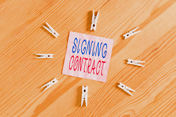 Writing note showing Signing Contract. Business concept for the parties signing the document agree...