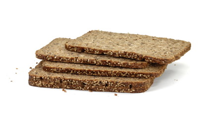 Slices of wholemeal dark bread isolated on a white background in close-up (high details)
