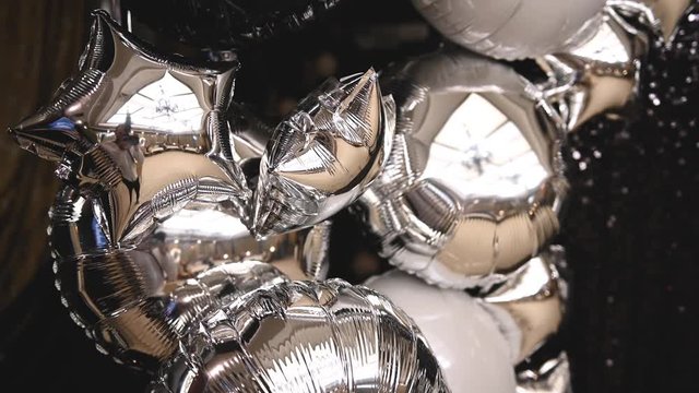 mirror inflatable helium balloons resembling stars at a holiday