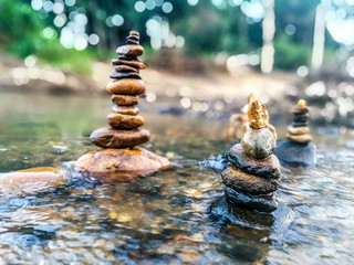 Close-up of stack of stones in perfect balance accomplish work is successful Stacked stones , Rock balancing or stone balancing (stone or rock stacking) Stacked stones Near the river